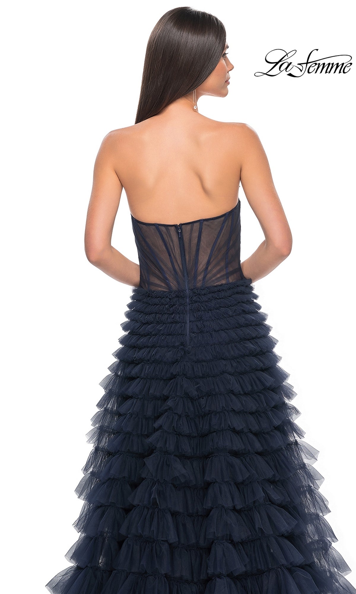 A woman with long straight hair models the La Femme Strapless Long Ruffled Prom Dress 32283, a navy blue a-line gown shown from the back. The La Femme logo appears in the upper right corner.